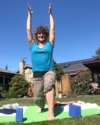 Tracey in yoga high lunge pose outdoors